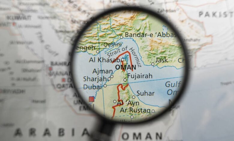map of strait of hormuz and surrounding area under magnifying glass illustration