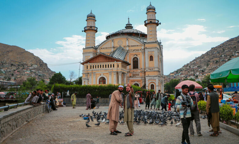 Tourists taking a selfie in front of the Shah Do Shamshira Mosque in Kabul Afghanistan