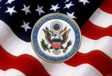 us department of state dos emblem over american flag serge averbukh